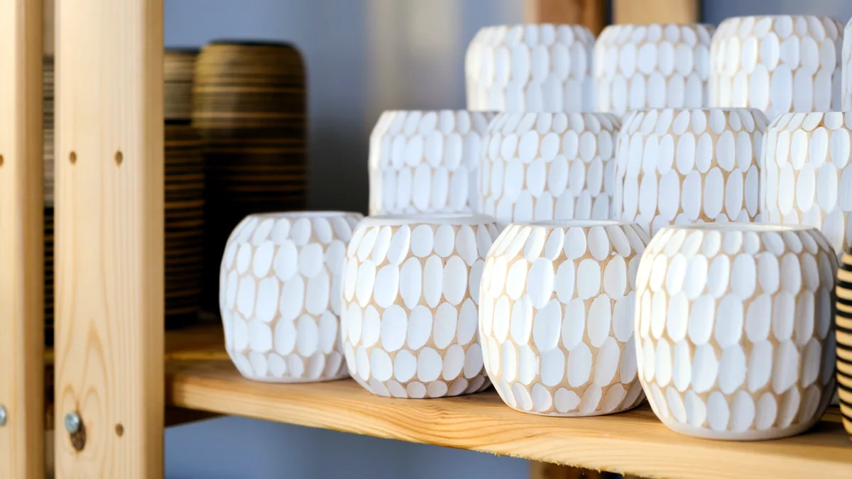 Blocks of foam padding and a chest protector lined up on a wooden shelf.